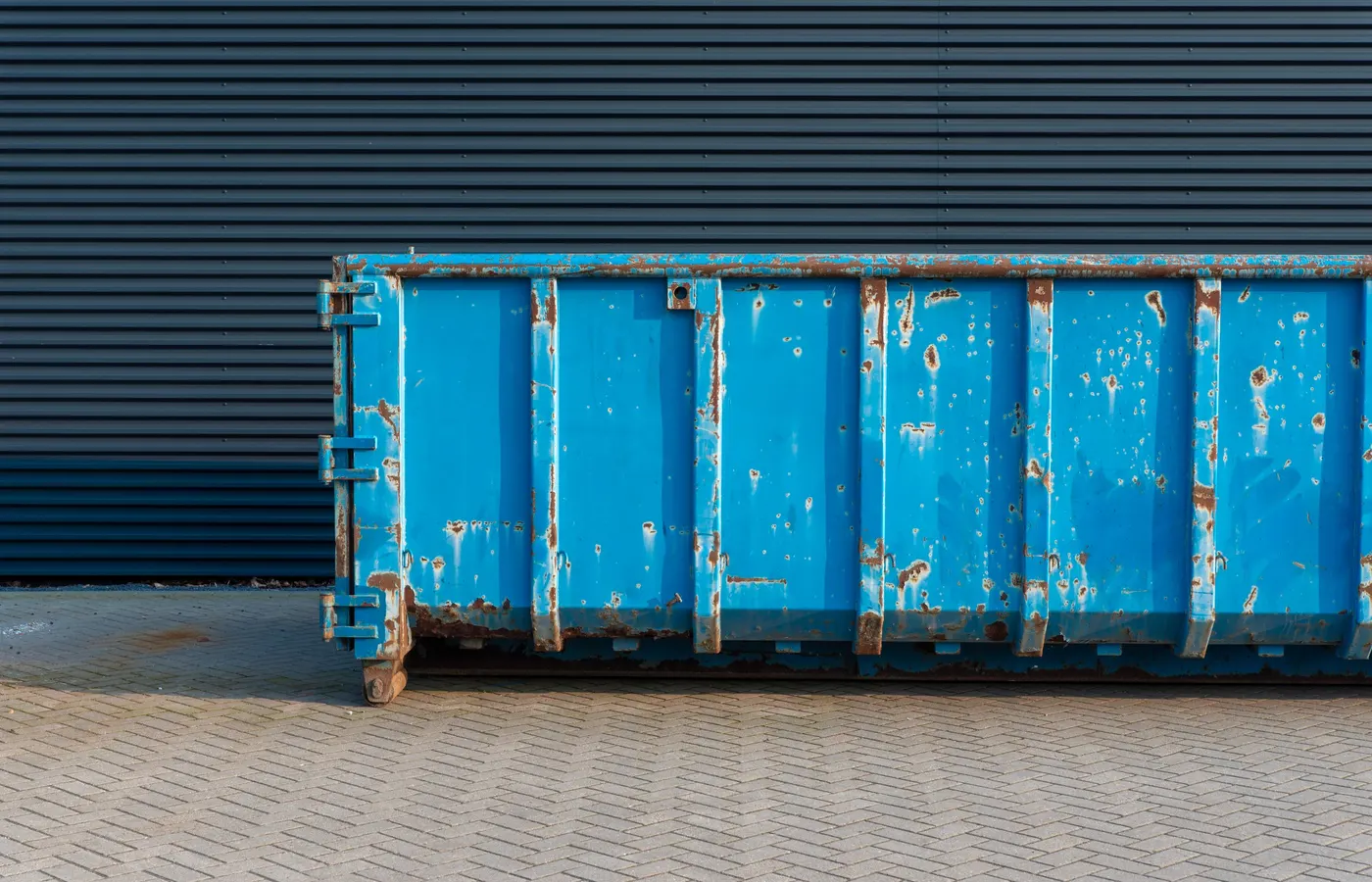 Commercial dumpster staged outside a building for junk removal in Buena Park, CA